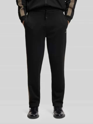 Spodnie sportowe o kroju relaxed fit z lampasami model ‘DOLOS’ HUGO