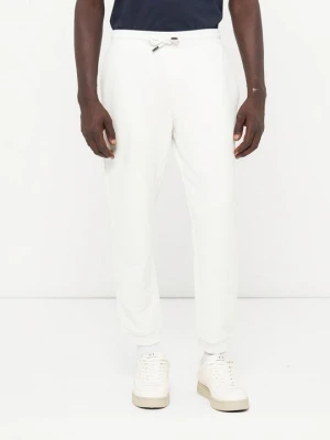 Spodnie treningowe Armani Exchange mleczny