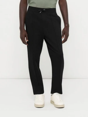 Spodnie treningowe Armani Exchange mleczny