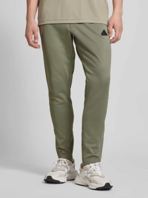 Spodnie treningowe o kroju regular fit z kieszeniami zapinanymi na zatrzaski model ‘TIRO’ adidas Sportswear