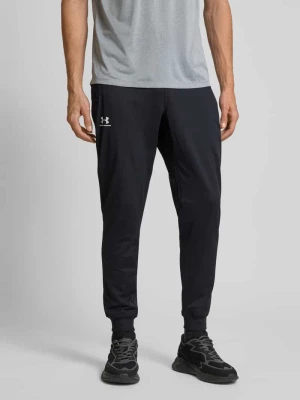 Spodnie treningowe o kroju relaxed fit z kieszeniami zapinanymi na zamek błyskawiczny Under Armour