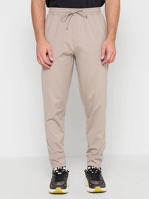 Spodnie treningowe Under Armour beżowy