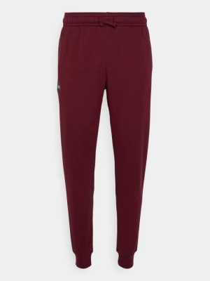 Spodnie treningowe Under Armour ciemnoczerwony