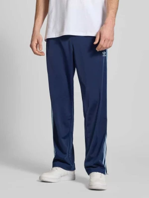 Spodnie treningowe z prostą nogawką i wyhaftowanym logo model ‘FIREBIRD’ adidas Originals
