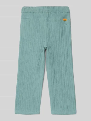 Spodnie z wpuszczanymi kieszeniami i haftem Steiff