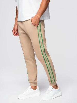 Sportowe spodnie męskie jogger z lampasami – brązowe V1 - Rozmiar: S Ombre Clothing