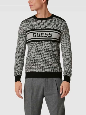 Sweter z dzianiny ze wzorem z logo na całej powierzchni ‘PALMER’ Guess