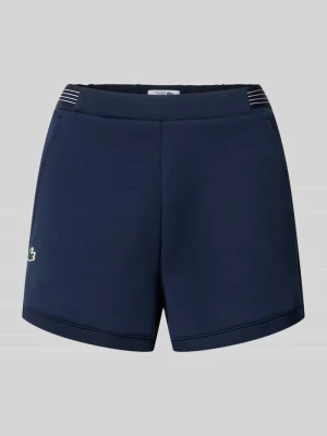 Szorty dresowe w kroju regular fit z aplikacją z logo Lacoste Sport