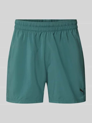 Szorty sportowe o kroju regular fit z nadrukiem z logo model „TAD ESSENTIALS” Puma Ciemnozielony