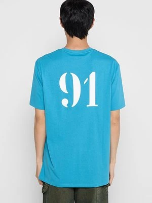 T-shirt z nadrukiem Armani Exchange jasnoniebieski
