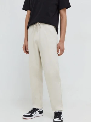 Tommy Jeans spodnie dresowe bawełniane kolor beżowy gładkie DM0DM18378