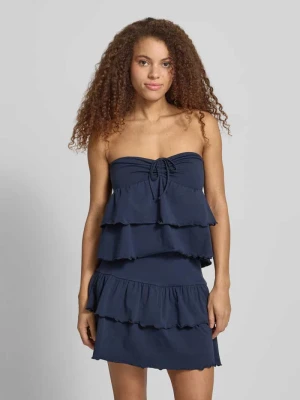 Top bandażowy w efekcie stopniowania z wiązaniem REVIEW